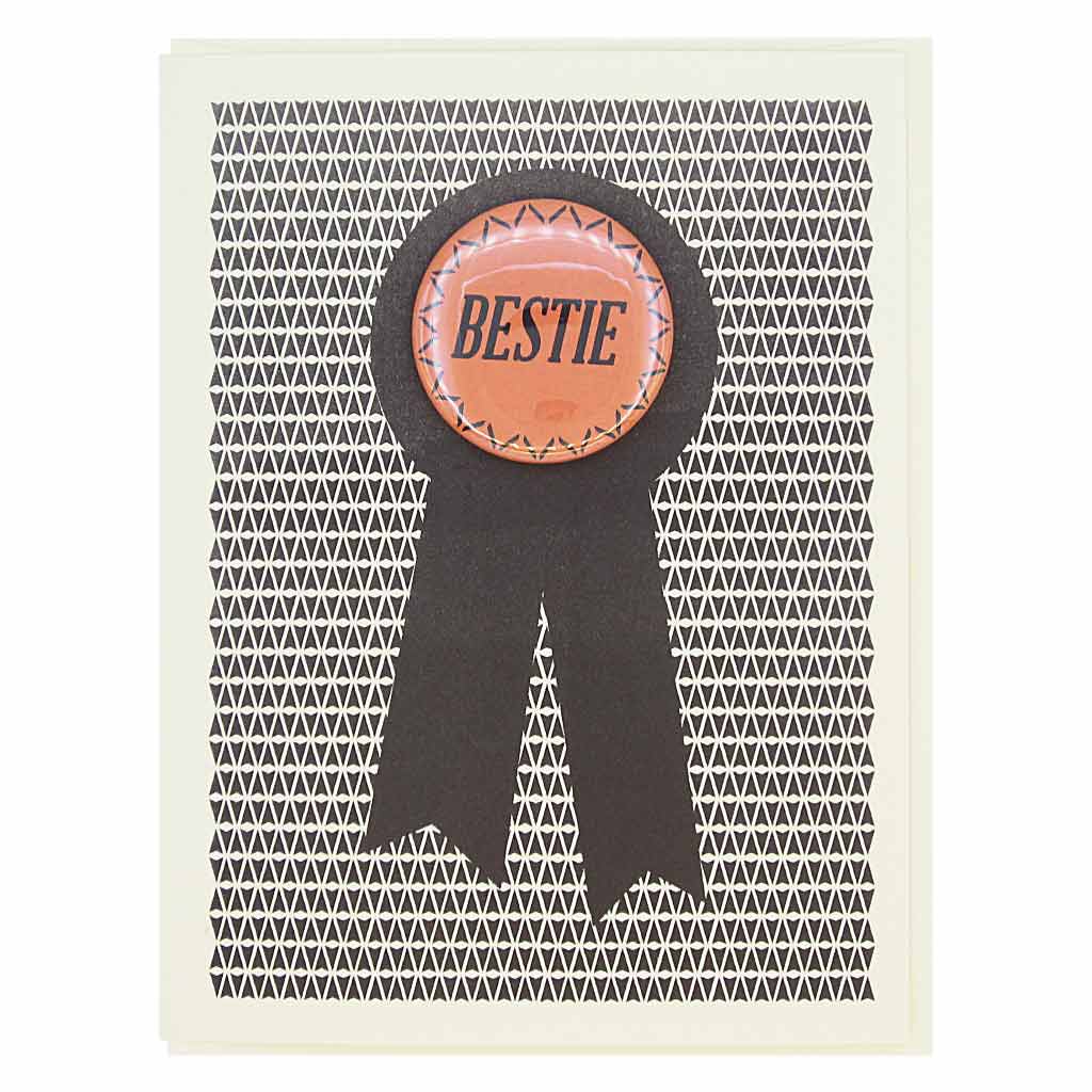 This card looks like a prize ribbon. Features a 1½” button with the text ‘Bestie’ that can be taken off and proudly worn by the recipient. Card measures 4¼” x 5½”, comes with a cream envelope & is blank inside. Designed by The Regional Assembly of Text.