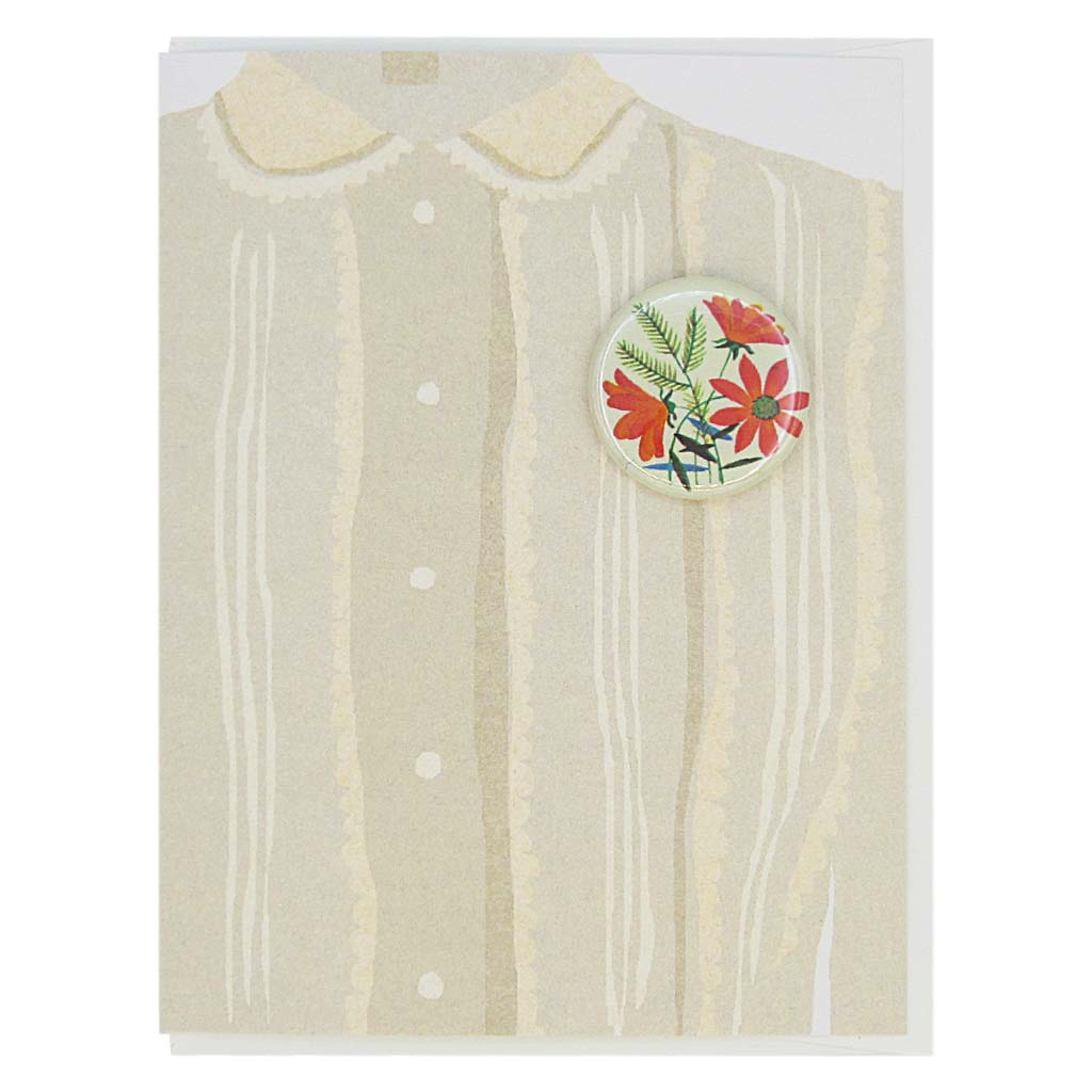 This greeting card is a collage of a pretty taupe blouse with a button of bouquet of orange flowers on the chest.  The button is 1¼” and can be taken off and proudly worn by the recipient. Card measures 4¼” x 5½”, comes with a white envelope & is blank inside. Designed by The Regional Assembly of Text.
