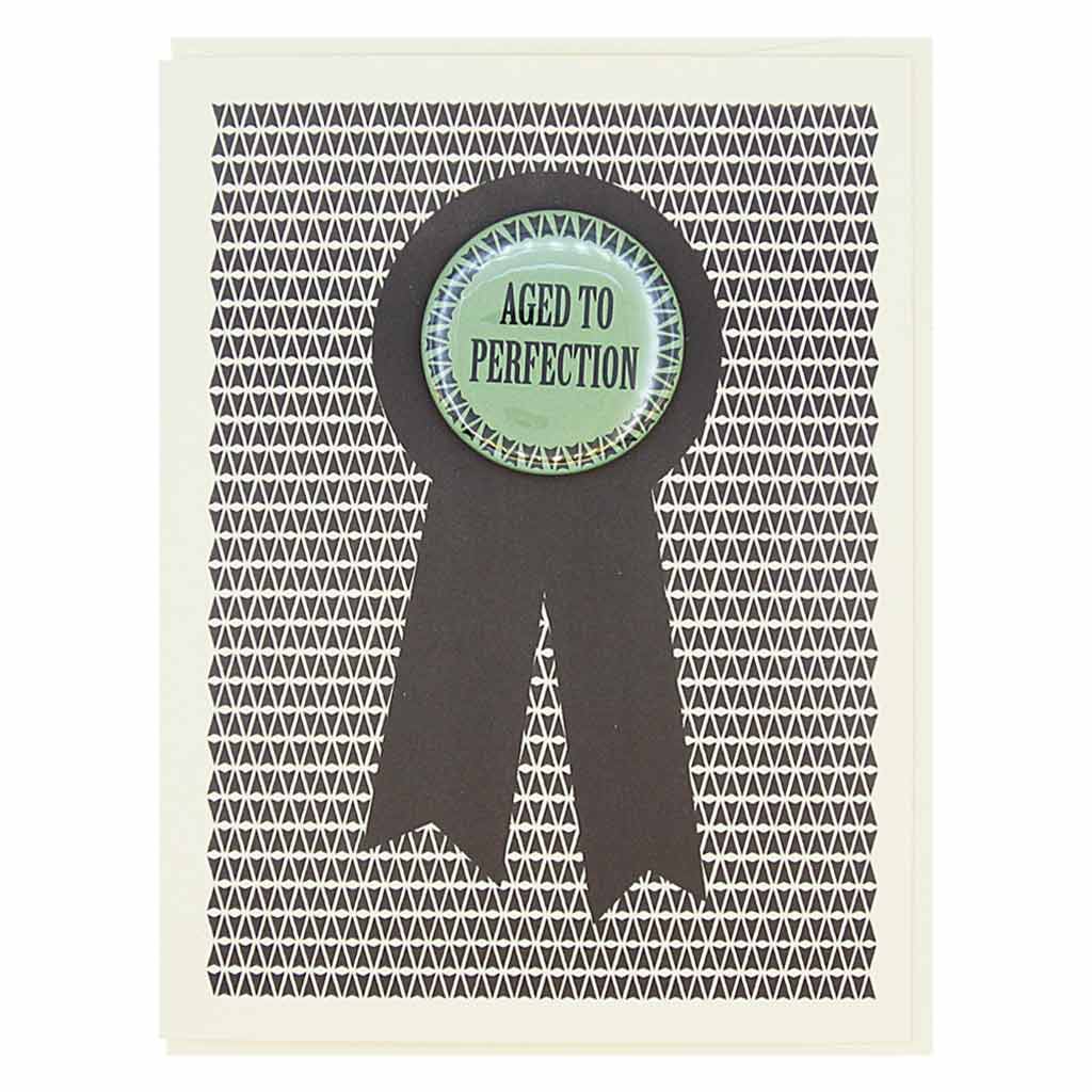 This birthday card looks like a prize ribbon. Features a 1½” button with the text 'Aged to Perfection' that can be taken off and proudly worn by the recipient. Card measures 4¼” x 5½”, comes with a cream envelope & is blank inside.