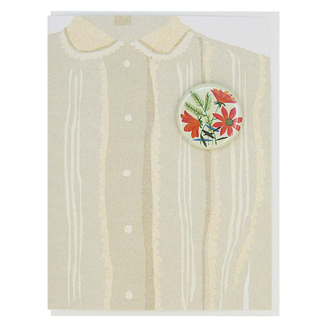 This greeting card is a collage of a pretty taupe blouse with a button of bouquet of orange flowers on the chest.  The button is 1¼” and can be taken off and proudly worn by the recipient. Card measures 4¼” x 5½”, comes with a white envelope & is blank inside. Designed by The Regional Assembly of Text.