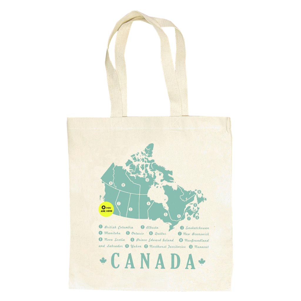 A durable, heavy weight canvas bag to tote around all your books and groceries. Features a minty green map of Canada and a 'You Are Here' button that can be taken off and moved around the country. Measures 14" x 16" with a sturdy handle.