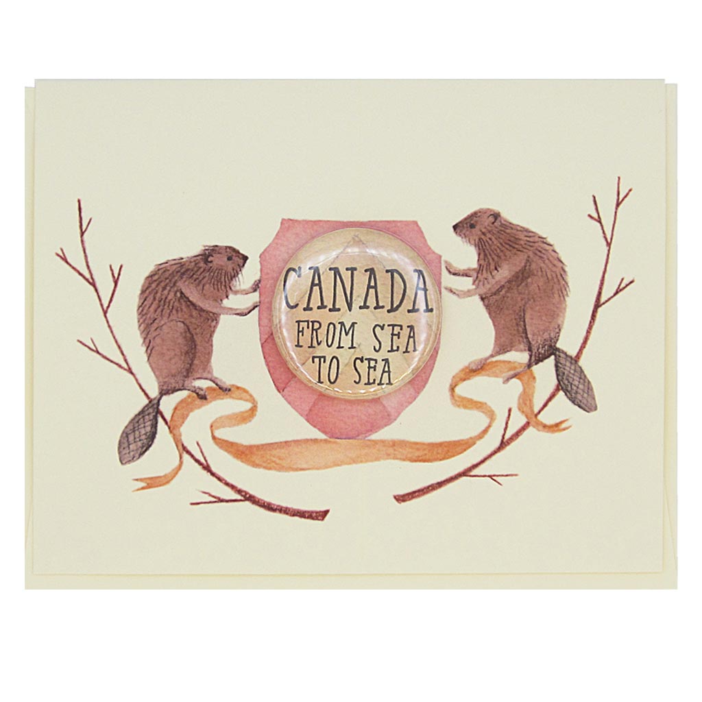 This beautiful greeting card features a watercolour painting of two beavers on either side of a crest. There is a 1½” button in the middle of the crest that reads ‘Canada, from sea to sea’. The button can be taken off and worn by the recipient. Card measures 4¼” x 5½”, comes with a cream envelope & is blank inside. Designed by The Regional Assembly of Text.