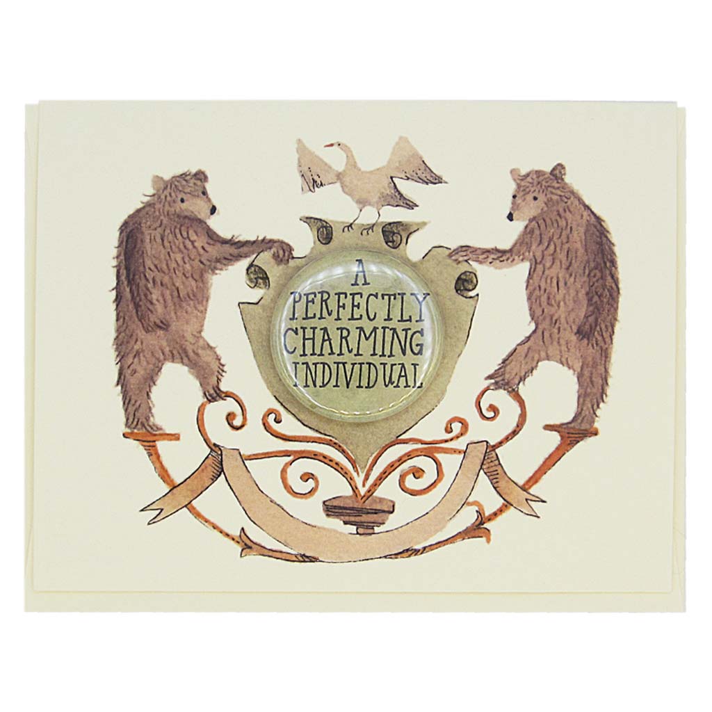 This lovely card features a watercolour painting of two bears on either side of a crest. There is a 1½” button in the middle of the crest that reads ‘a perfectly charming individual’. The button can be taken off and worn by the recipient. Card measures 4¼” x 5½”, comes with a cream envelope & is blank inside. Designed by The Regional Assembly of Text.