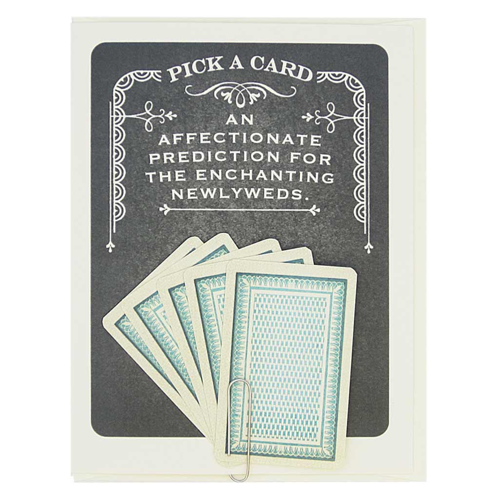 This card says Pick A Card… An Affectionate Prediction for the Enchanting Newlyweds, and has 5 tiny playing cards to choose from attached to the front of the card with a paperclip. Pick one to reveal the future. All fortunes are bright and cheery. Card measures 4¼” x 5½”, comes with a cream envelope & is blank inside. Designed by The Regional Assembly of Text.
