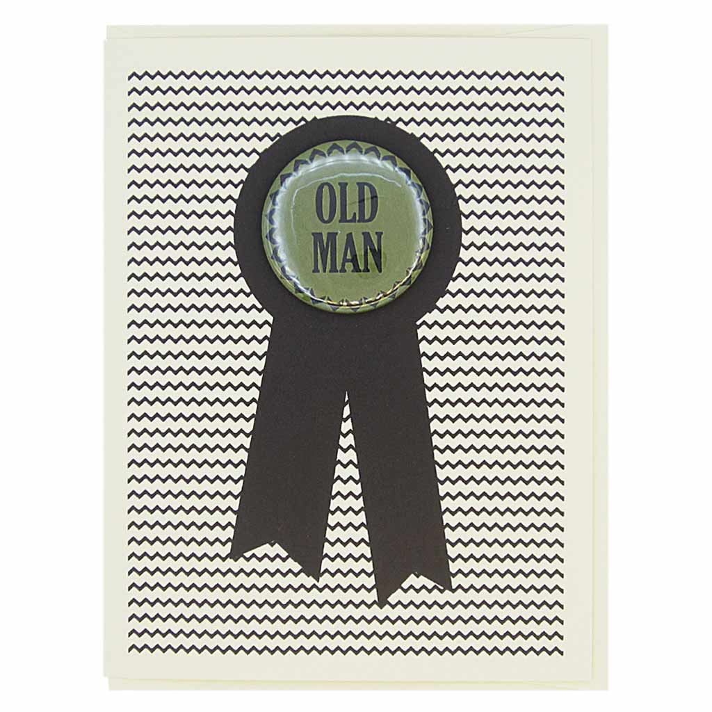 This popular birthday card is sure to make someone chuckle. Or offend them! This birthday card looks like a prize ribbon. Features a 1½” button with the text ‘Old Man’ that can be taken off and proudly worn by the recipient. Card measures 4¼” x 5½”, comes with a cream envelope & is blank inside. Designed by The Regional Assembly of Text.
