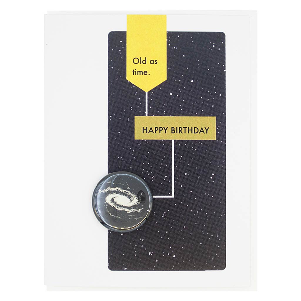 This birthday card is designed to look like a page from a vintage science textbook with a black background of a starry sky. The text reads, ‘Old as Time’ with an arrow to the text ‘Happy Birthday’ with an arrow to a 1¼” button of the Milky Way that can be taken off and worn by the recipient. Card measures 4¼” x 5½”, comes with a white envelope & is blank inside. Designed by The Regional Assembly of Text.