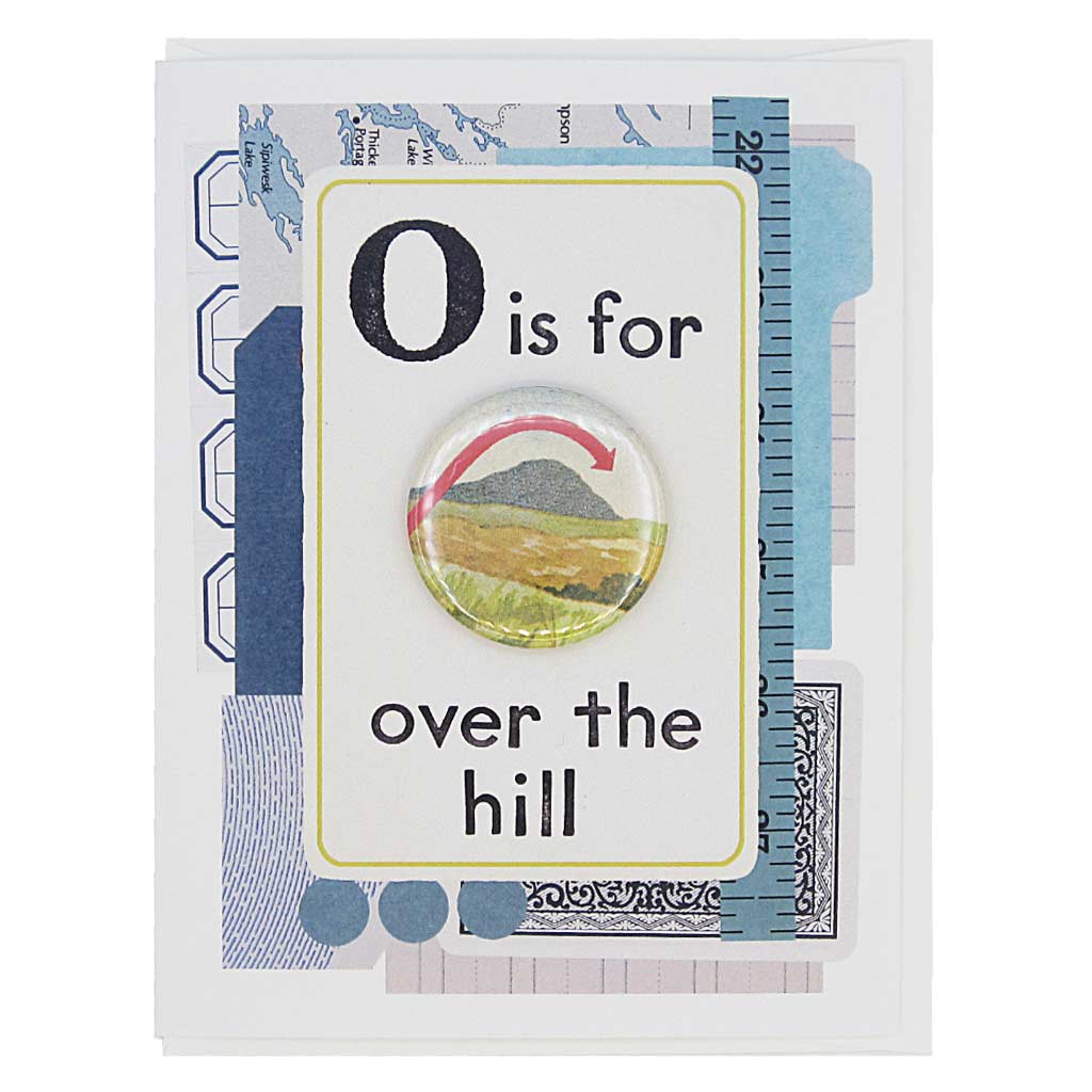 This birthday card looks like a vintage flashcard and says O is for Over the Hill. It features a 1½” button of a hill with an arrow going over it that can be taken off and worn by the recipient. Card measures 4¼” x 5½”, comes with a white envelope & is blank inside. Designed by The Regional Assembly of Text.