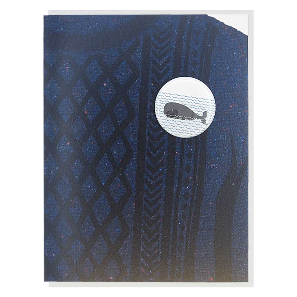 This greeting card is a collage of a navy cable knit sweater with a button of a whale on the chest.  The button is 1¼” and can be taken off and proudly worn by the recipient. Card measures 4¼” x 5½”, comes with a white envelope & is blank inside. Designed by The Regional Assembly of Text.